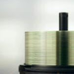 Stos płyt CD na szpindlu z widoczną błyszczącą powierzchnią