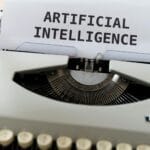 Zbliżenie maszyny do pisania z tekstem artificial intelligence na kartce